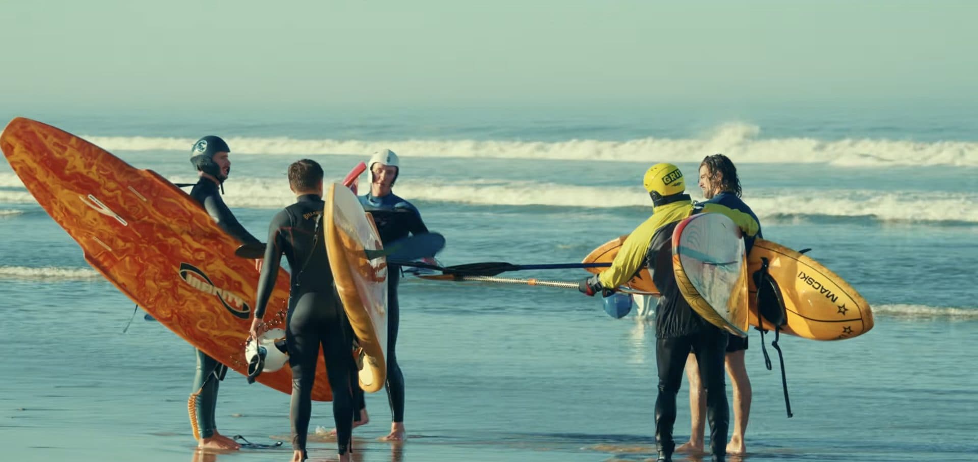 The full squad gathered at the shoreline with their waveskis